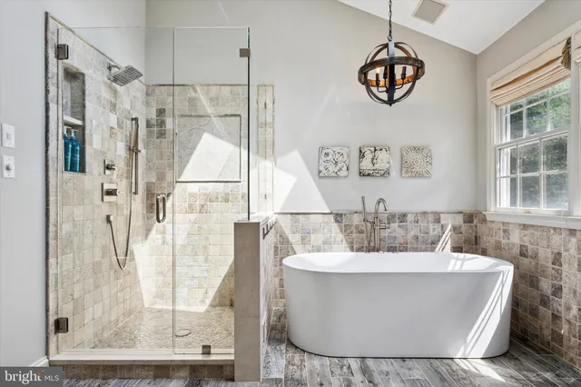 a white bath tub sitting next to a bathroom