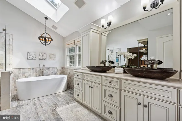 a spacious bathroom with a double sink and a mirror