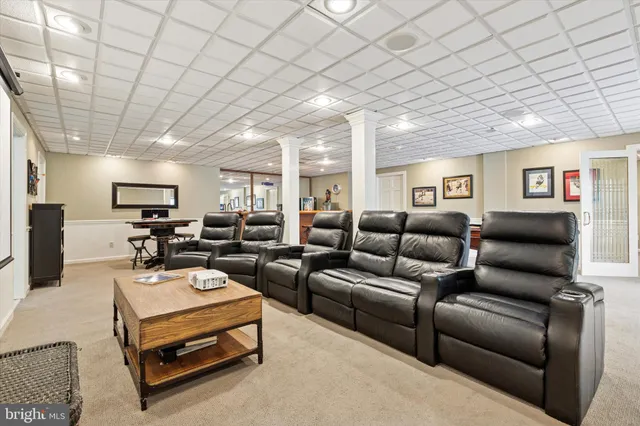 a living room with furniture a wooden floor and chandelier