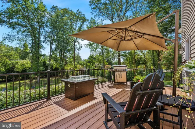 a view of a roof deck with chair and wooden floor