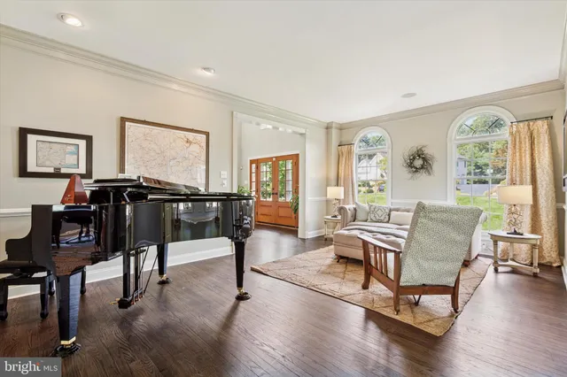 a living room with furniture and a flat screen tv with wooden floor