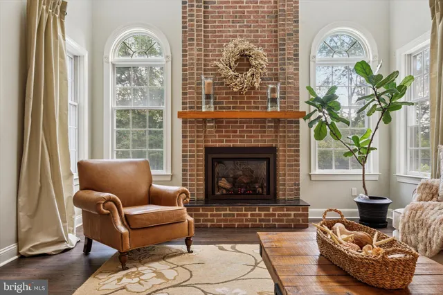 a living room with furniture a lamp and a fireplace