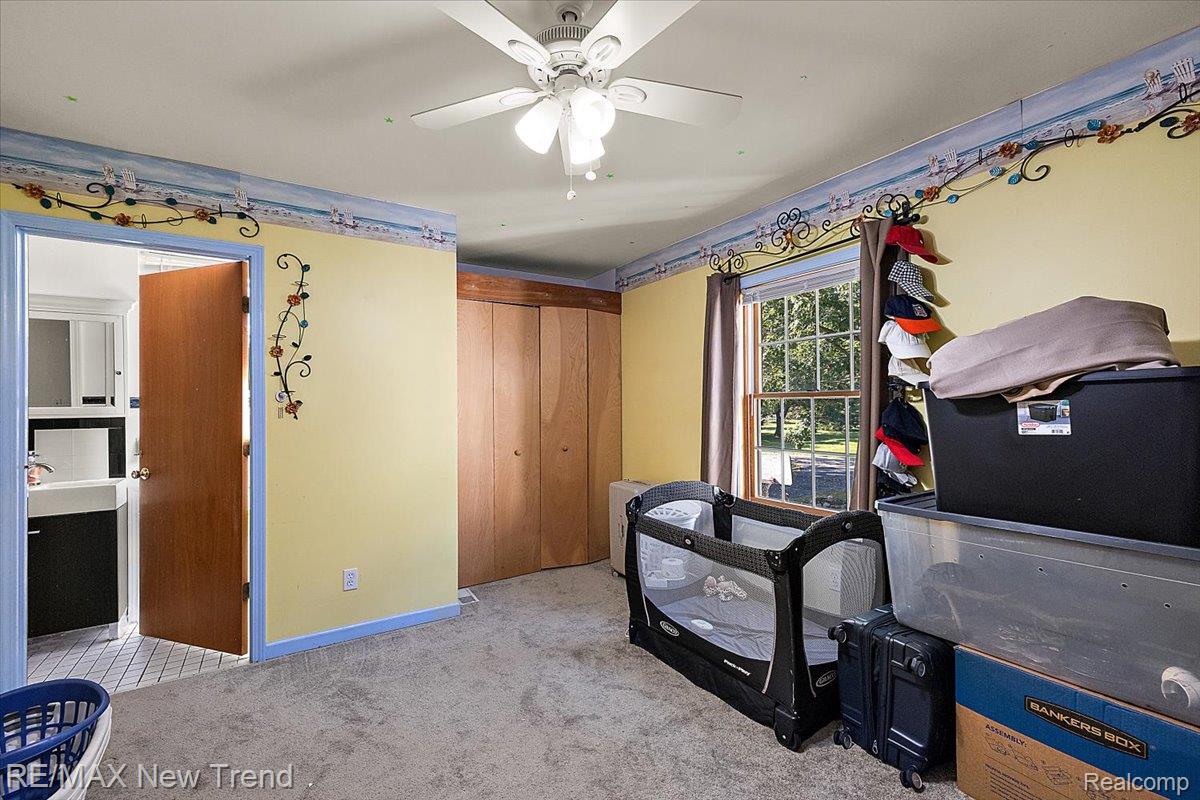 1450 Lenox Road Bloomfield Hills, MI 48304 - Photo 62 of 79 Carpeted room with a ceiling fan, a window with curtains, and bifold closet doors