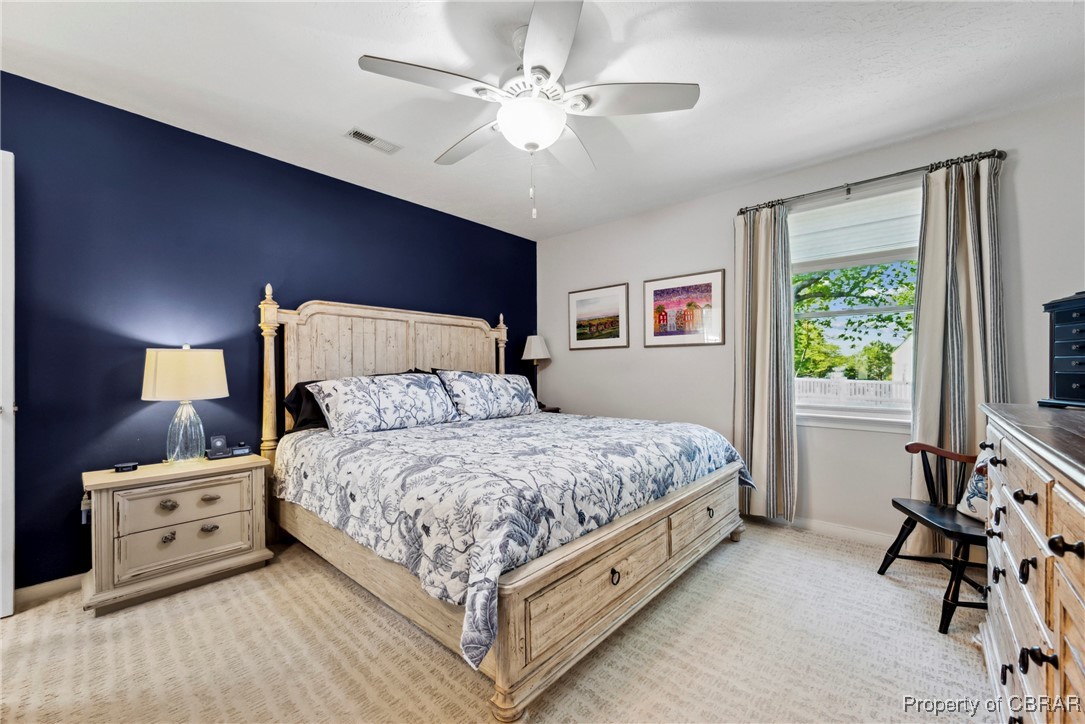 298 Old Ferry Road Hudgins, VA 23076 - Photo 15 of 48 Bedroom with visible vents, a ceiling fan, baseboards, and light carpet
