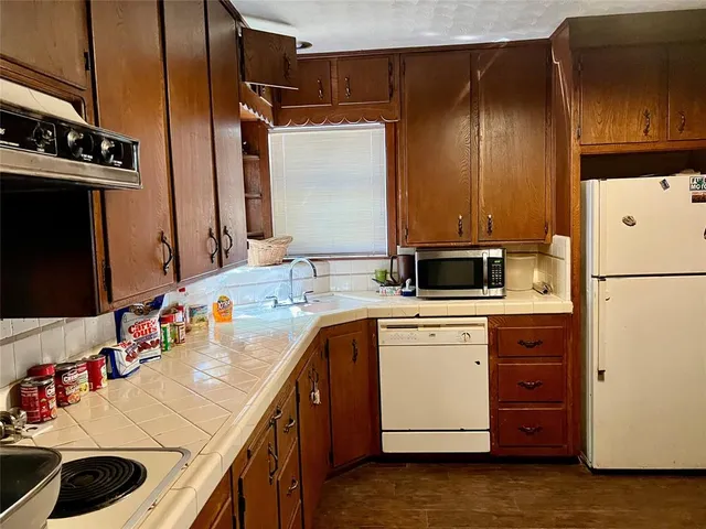 a kitchen with a sink and refrigerator