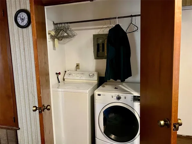 a view of a storage and utility room with a washer dryer