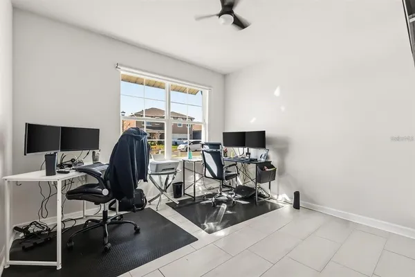 a view of a workspace with furniture and a window