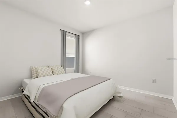 a bedroom with a bed and a window