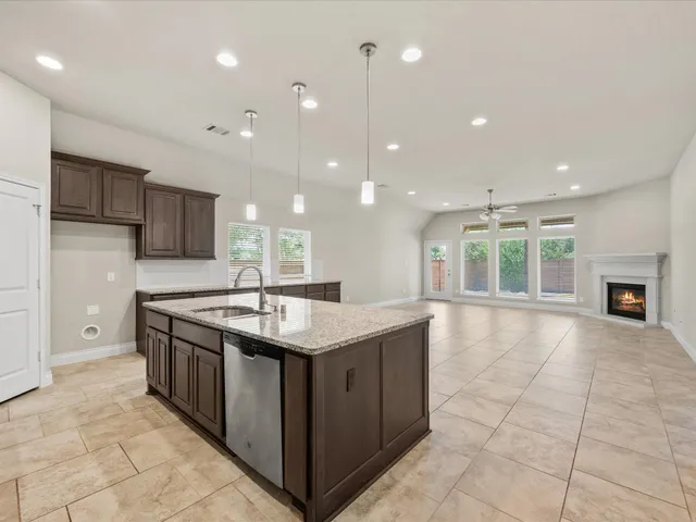 a kitchen with stainless steel appliances granite countertop a stove and a sink