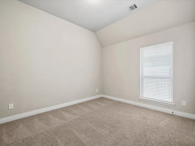 a room with gym equipment and windows