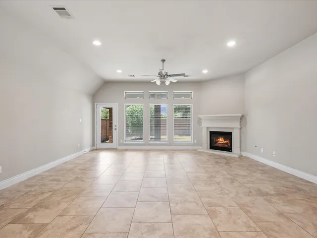 a view of an empty room with a fireplace