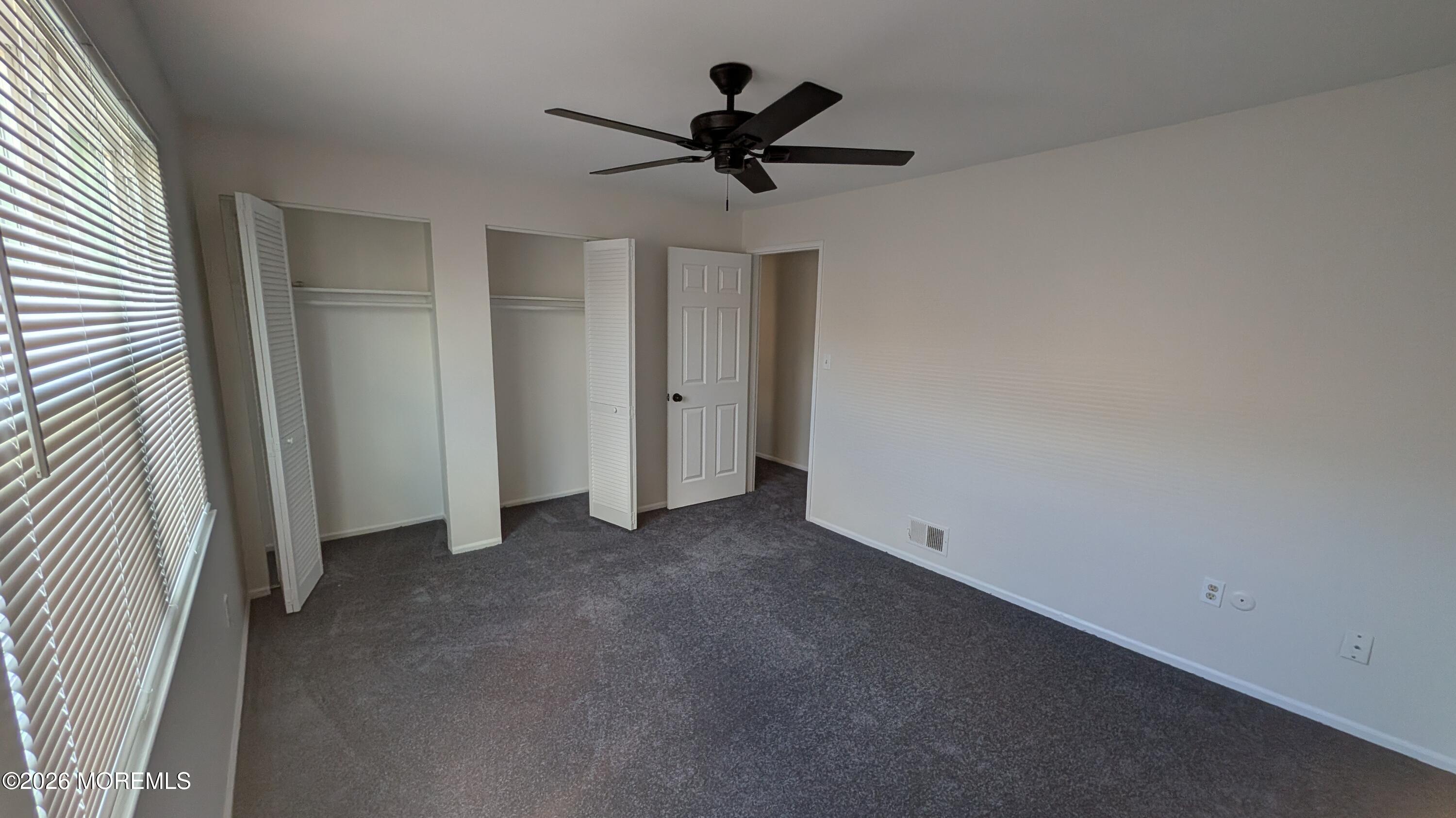 230 Sawmill Road, Unit A Brick, NJ 08724 - Photo 17 of 21 an empty room with closet and a ceiling fan