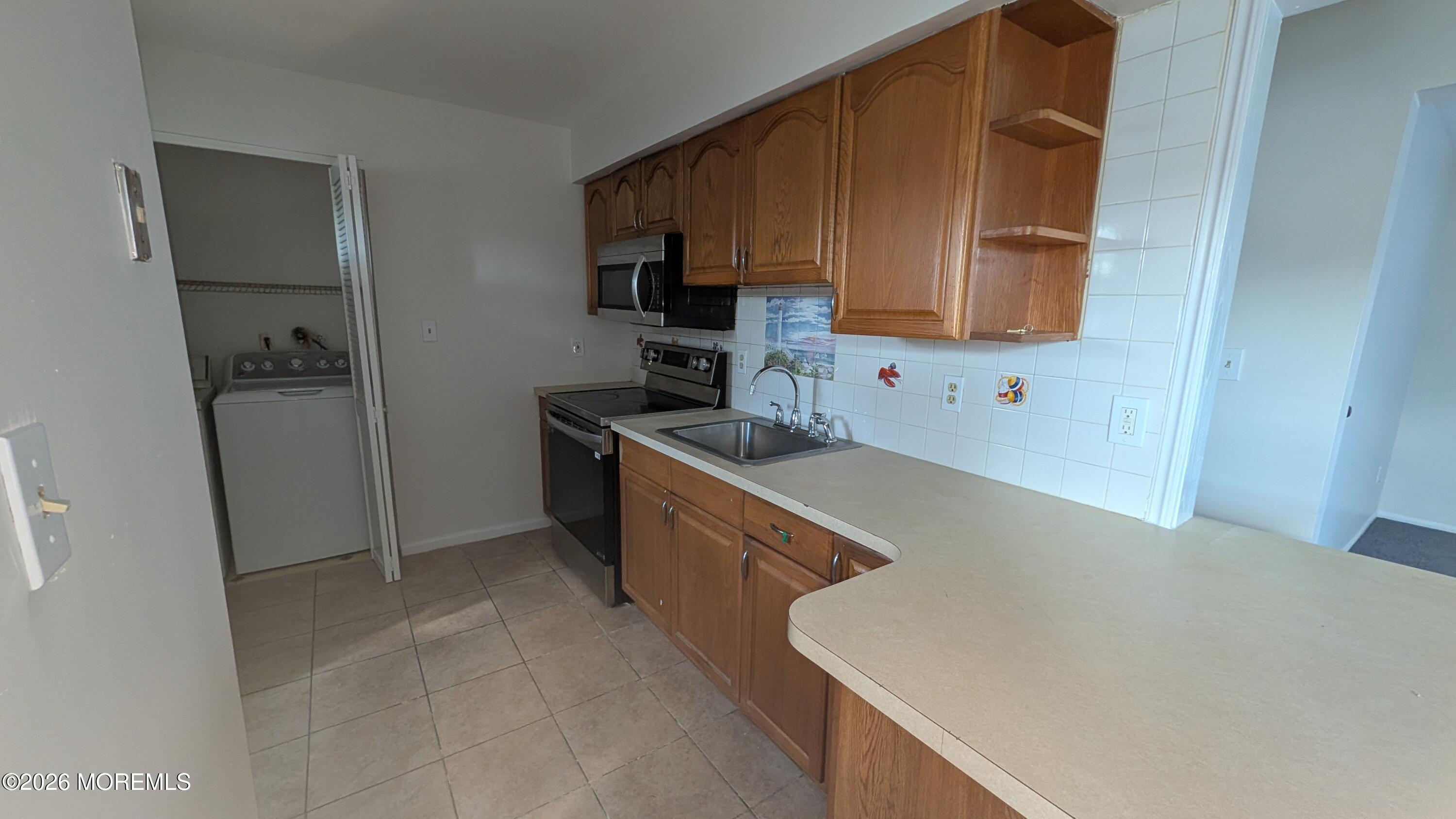 230 Sawmill Road, Unit A Brick, NJ 08724 - Photo 2 of 21 a kitchen with stainless steel appliances a sink a stove a refrigerator a cabinets and wooden floor