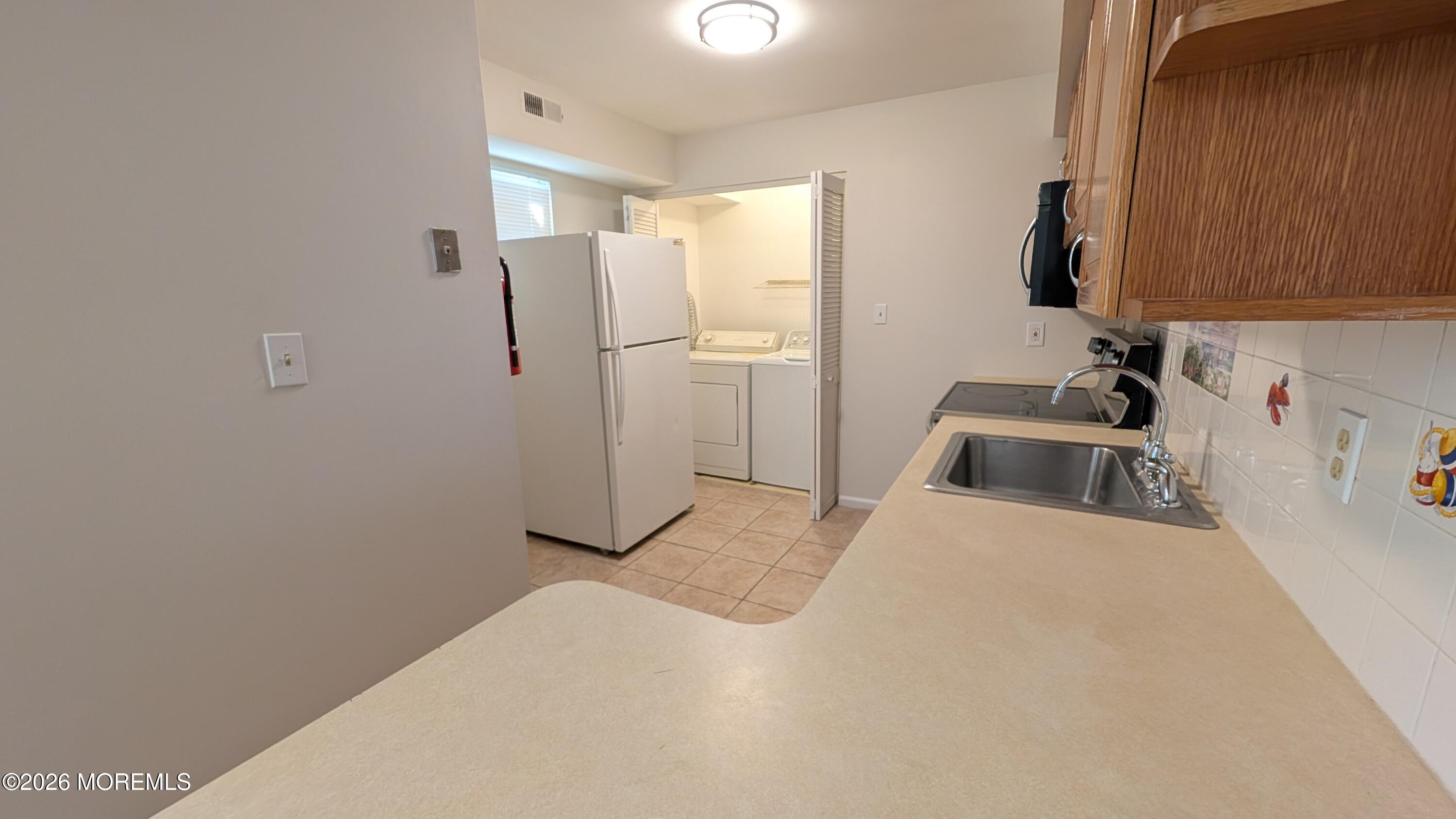 230 Sawmill Road, Unit A Brick, NJ 08724 - Photo 3 of 21 Kitchen and Laundry Closet