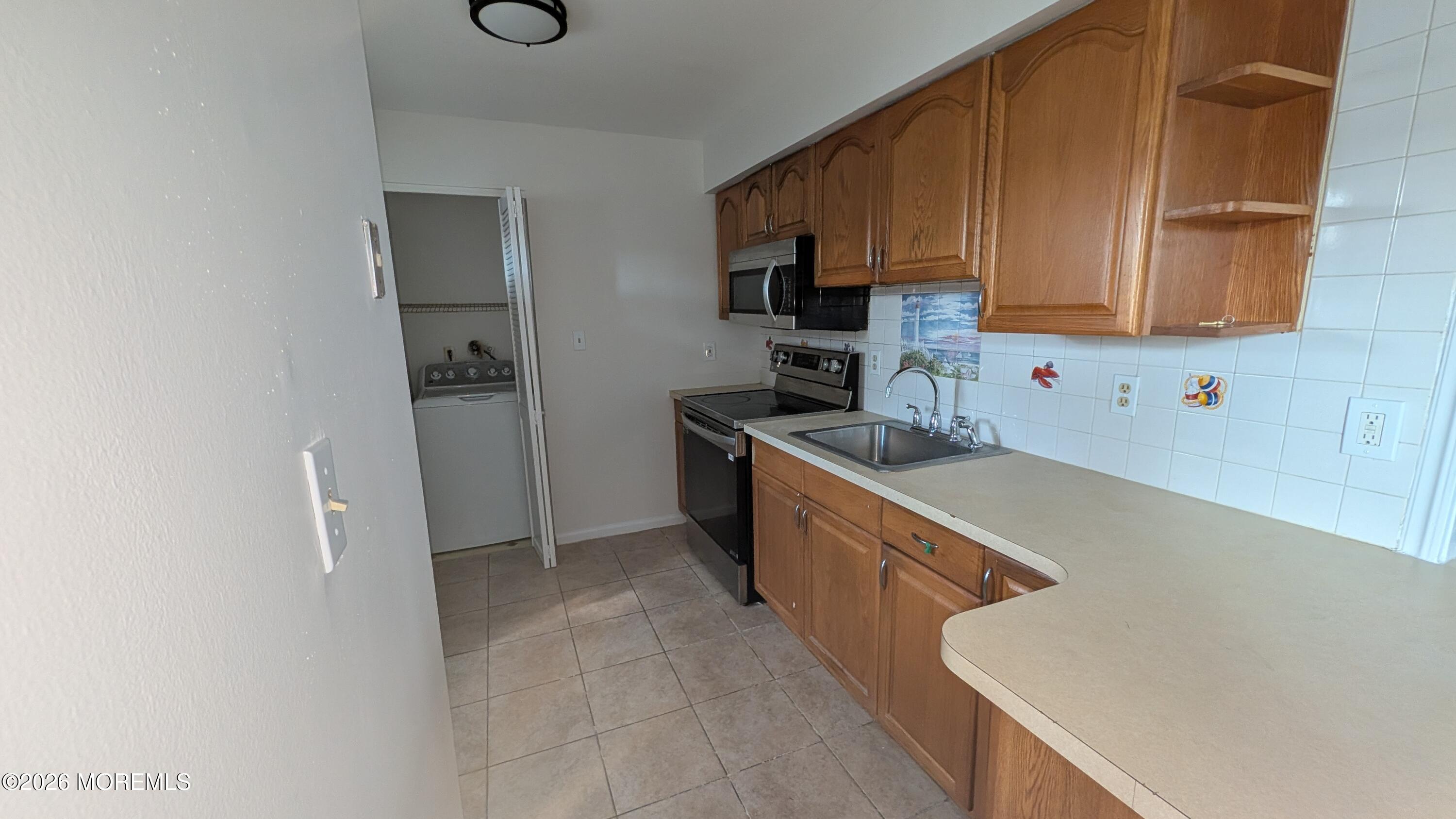 230 Sawmill Road, Unit A Brick, NJ 08724 - Photo 3 of 21 a kitchen with stainless steel appliances granite countertop a sink stove and refrigerator