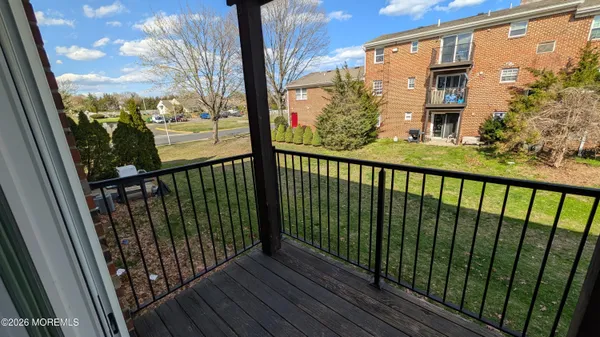 a view of a balcony with wooden floor