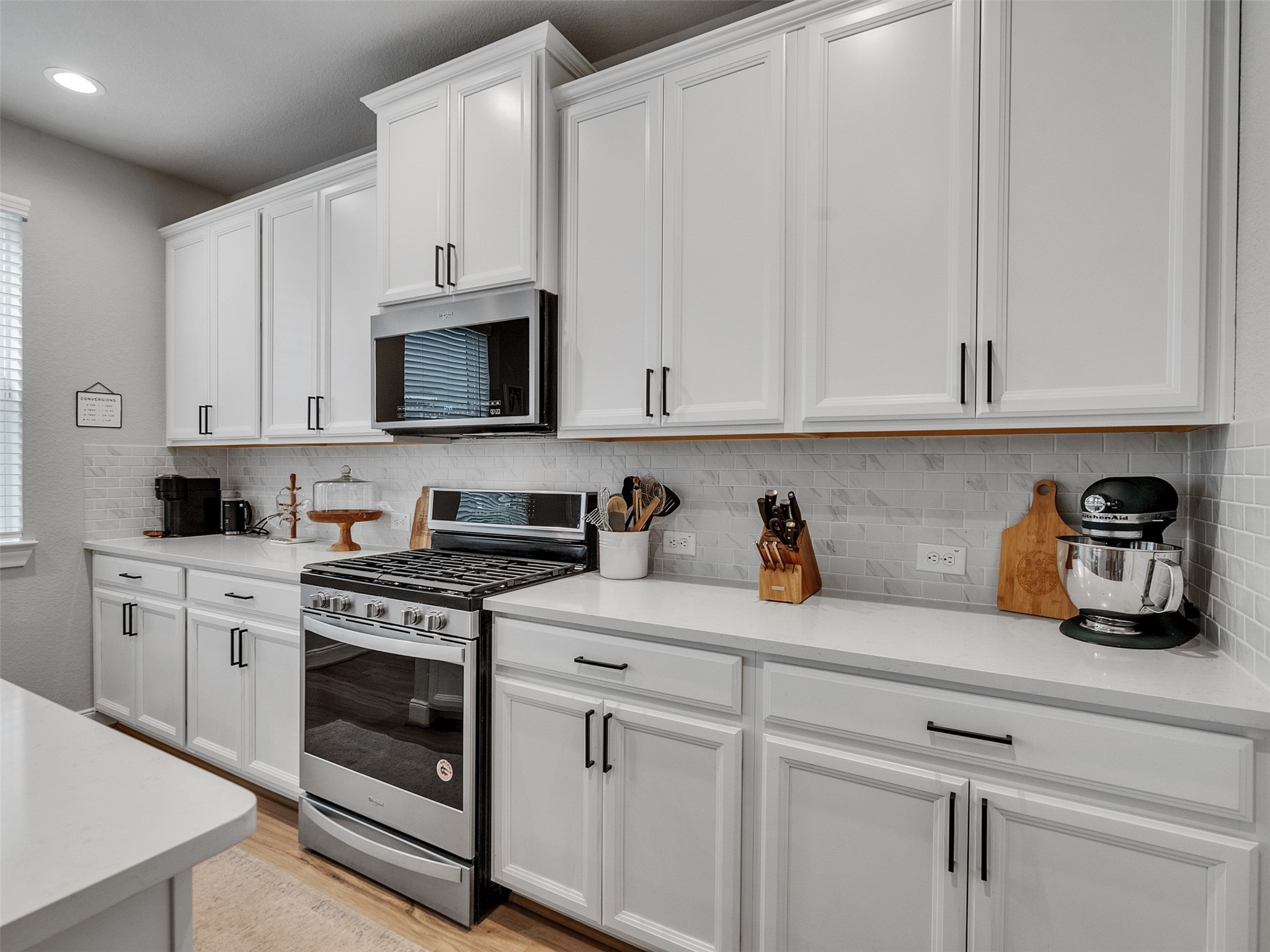 3118 Cloud Forest Lane Houston, TX 77080 - Photo 10 of 40 a kitchen with white cabinets and white appliances