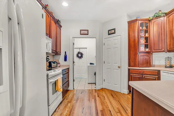 a bathroom with double vanity sinks a vanity a lamp and a mirror