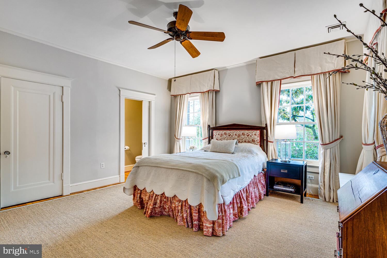 3512 Rittenhouse Street Northwest Washington, DC 20015 - Photo 60 of 132 a spacious bedroom with a bed a chandelier and a window