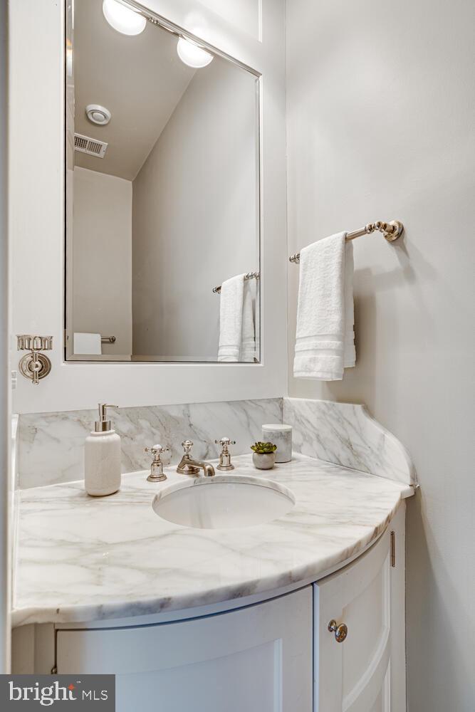 3512 Rittenhouse Street Northwest Washington, DC 20015 - Photo 61 of 132 a bathroom with a granite countertop sink and a mirror