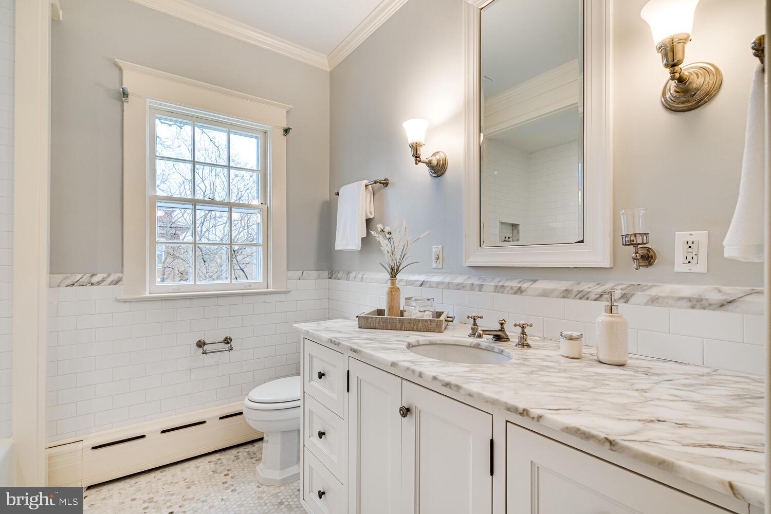 3512 Rittenhouse Street Northwest Washington, DC 20015 - Photo 65 of 132 a bathroom with a granite countertop sink a toilet and a mirror