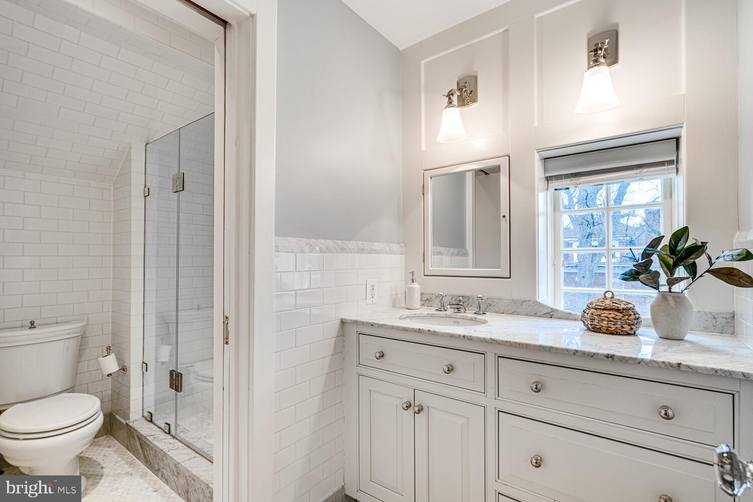 3512 Rittenhouse Street Northwest Washington, DC 20015 - Photo 77 of 132 a bathroom with a toilet a sink and glass door