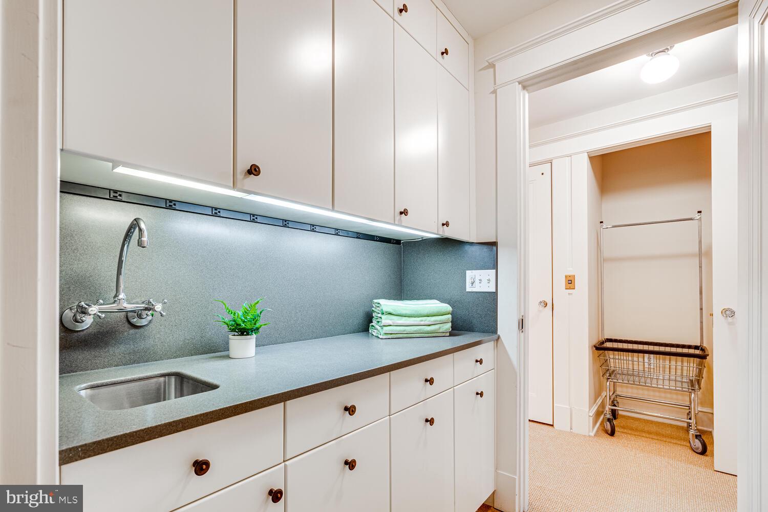 3512 Rittenhouse Street Northwest Washington, DC 20015 - Photo 82 of 132 a kitchen with white cabinets and a sink