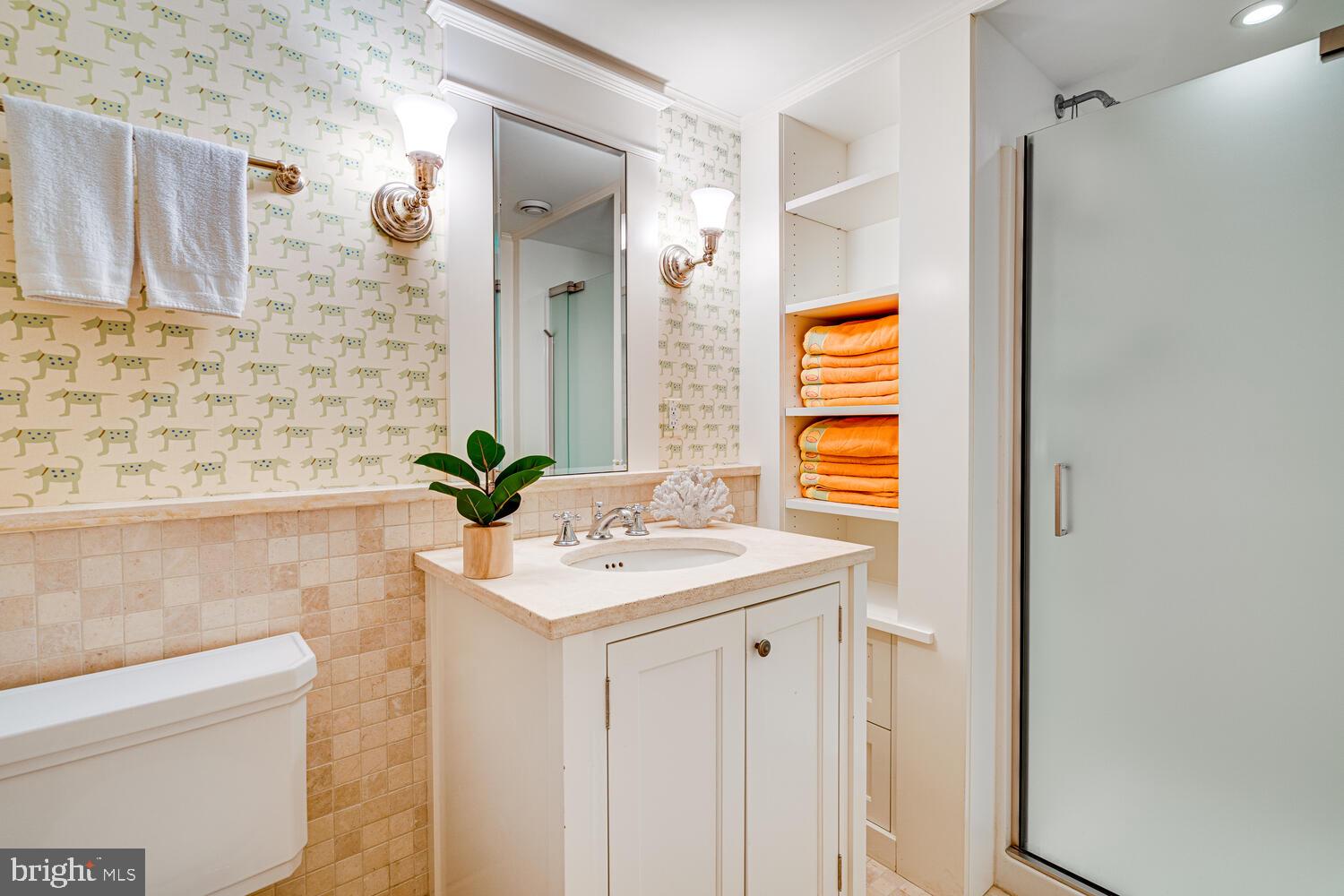 3512 Rittenhouse Street Northwest Washington, DC 20015 - Photo 90 of 132 a bathroom with a sink a mirror and a shower