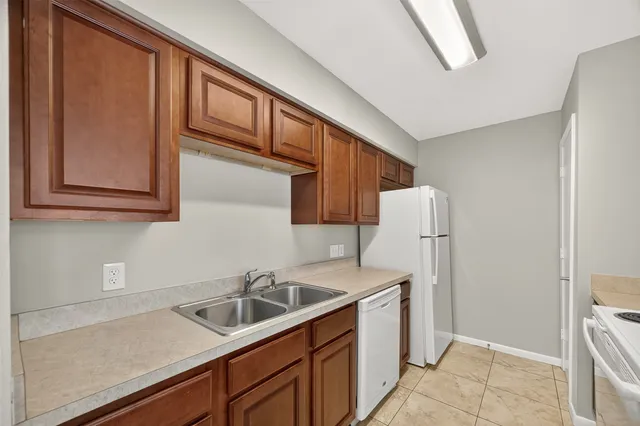 a kitchen with a sink cabinets and utility