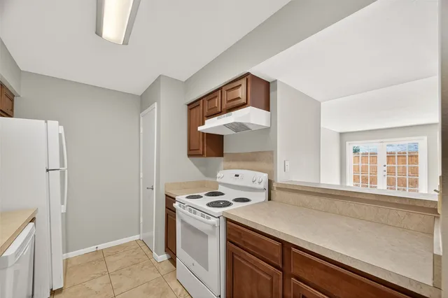 a kitchen with a stove cabinets and a refrigerator
