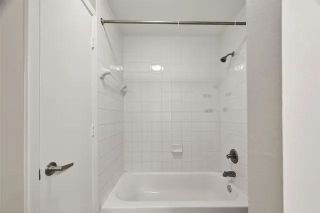 a bathroom with a shower and a bath tub