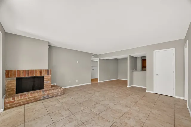 a view of empty room with a fireplace and cabinet