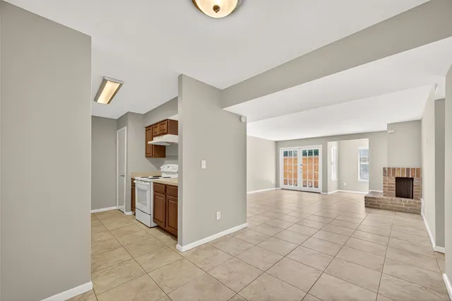 a view of a kitchen with furniture and an empty room
