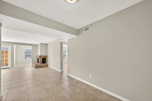 a view of a livingroom with an empty space and a window