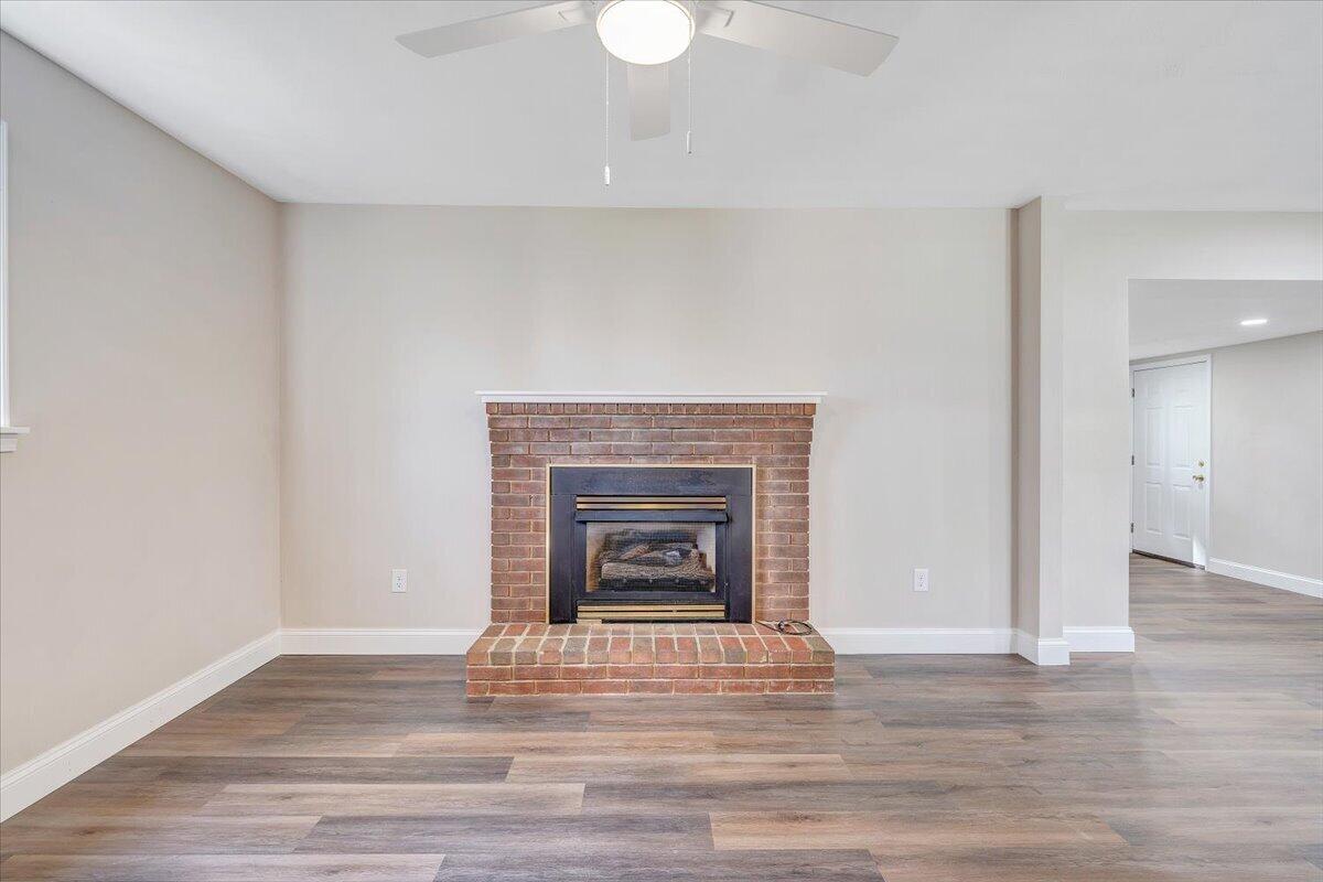 2159 Beavers Lane Vinton, VA 24179 - Photo 22 of 45 a view of an empty room with wooden floor fireplace and a window