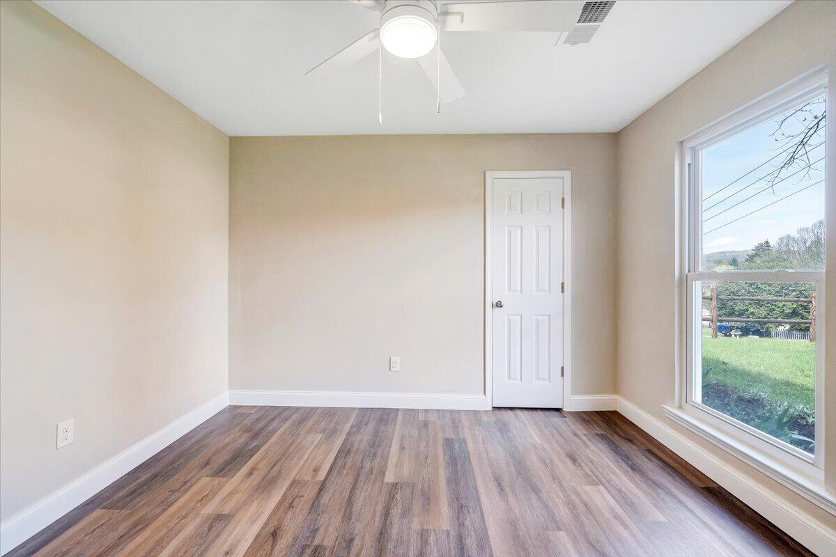 2159 Beavers Lane Vinton, VA 24179 - Photo 31 of 45 an empty room with wooden floor and windows