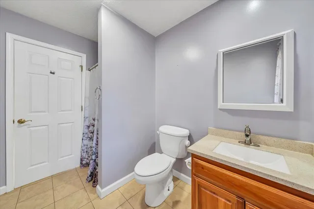 a kitchen with a refrigerator a table and chairs