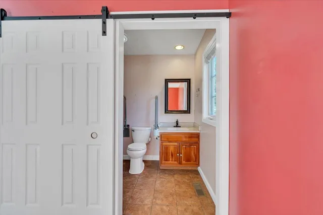 a living room with furniture a fireplace and a large window