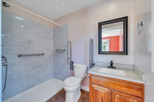 a bedroom with a bed and a chair in it