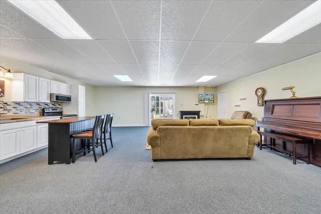 a view of a house with a yard and large tree
