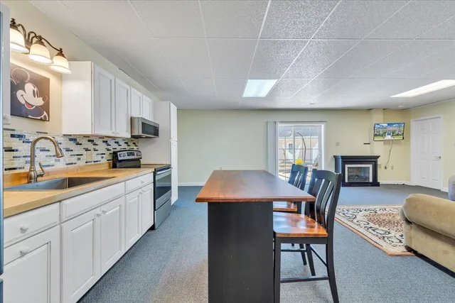 a view of a house with a yard and garage