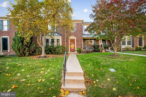 front view of a brick house with a yard