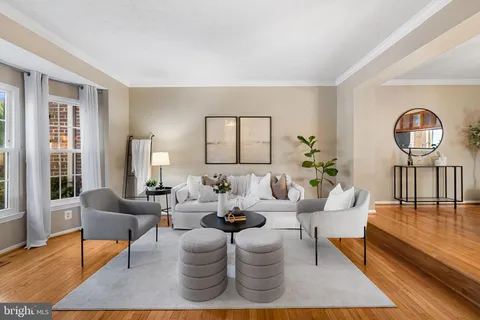 a living room with furniture potted plant and a large window