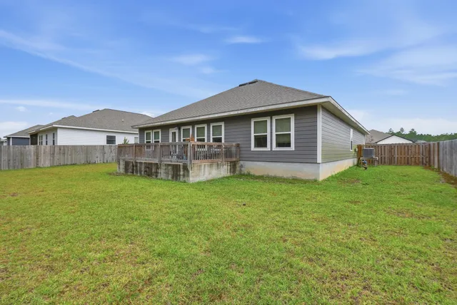 a view of a house with a yard and sitting area