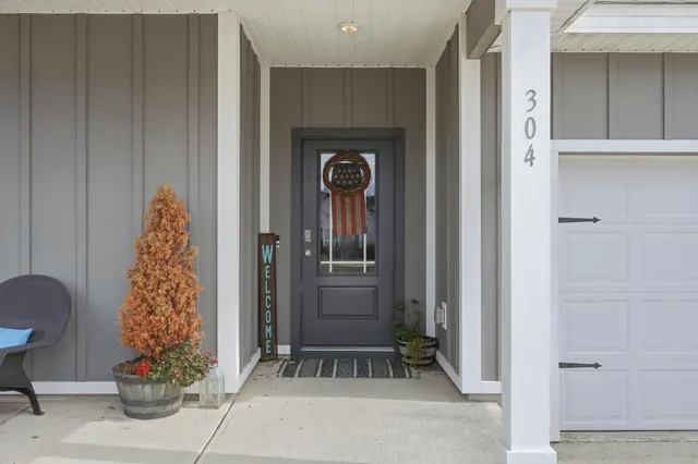 a kitchen with stainless steel appliances granite countertop a sink and a stove top oven with wooden floor