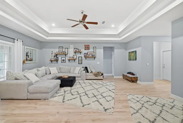 a living room with furniture and a view of kitchen