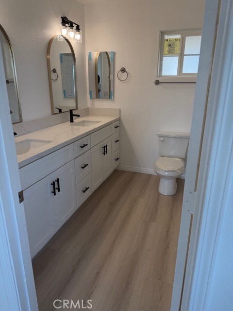 16925 Nanticoke Road Apple Valley, CA 92307 - Photo 33 of 87 a bathroom with a double vanity sink and a mirror