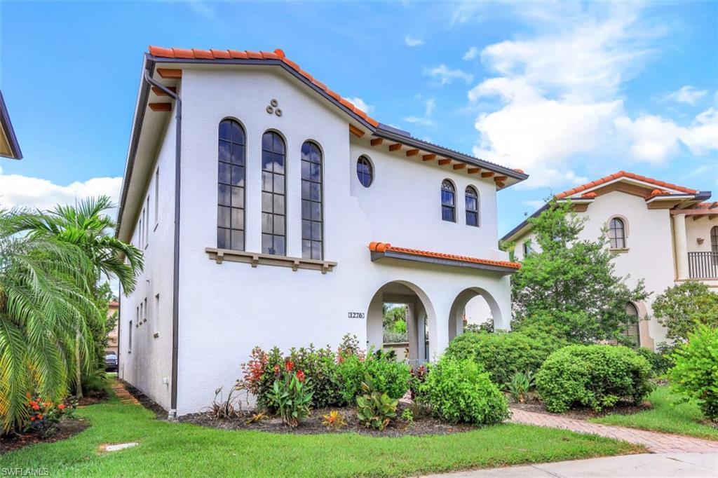 1276 Kendari Terrace Naples, FL 34113 - Photo 1 of 31 a front view of a house with garden