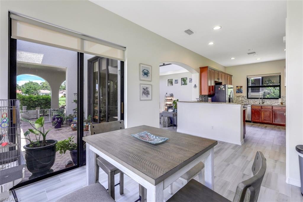 1276 Kendari Terrace Naples, FL 34113 - Photo 13 of 31 a kitchen with a table and chairs in it