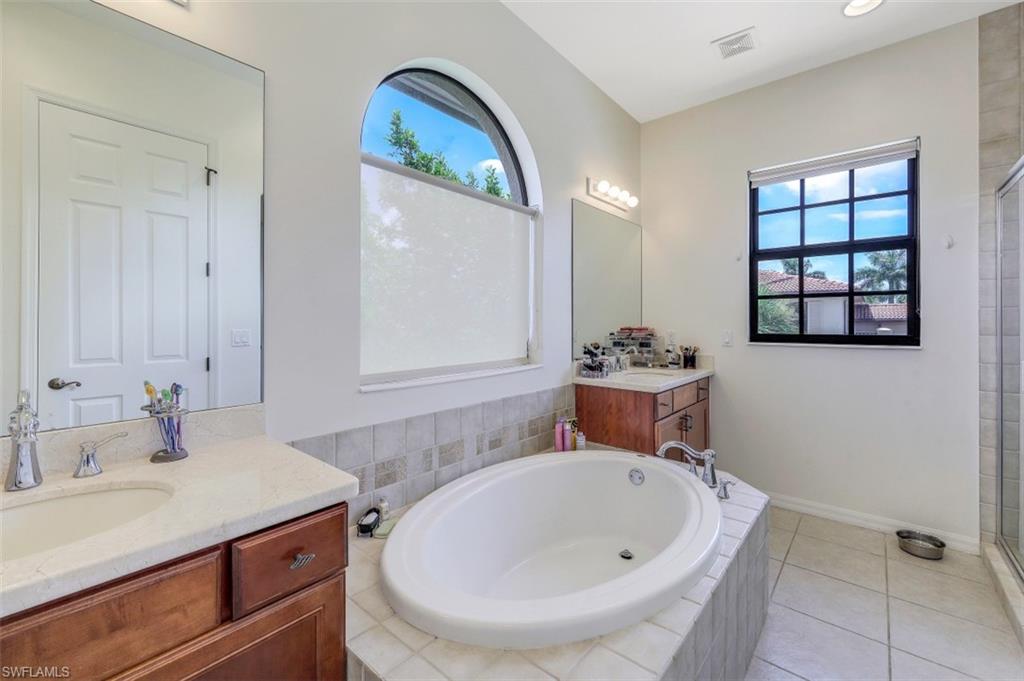 1276 Kendari Terrace Naples, FL 34113 - Photo 18 of 31 a bathroom with a sink and a mirror